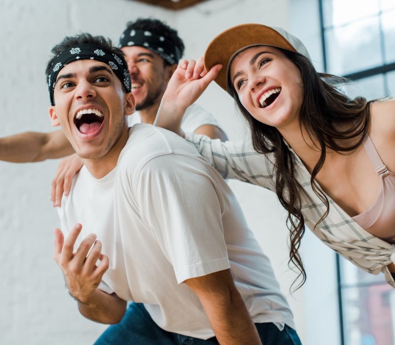 selective-focus-of-cheerful-multicultural-dancers-laughing-in-dance-studio.jpg