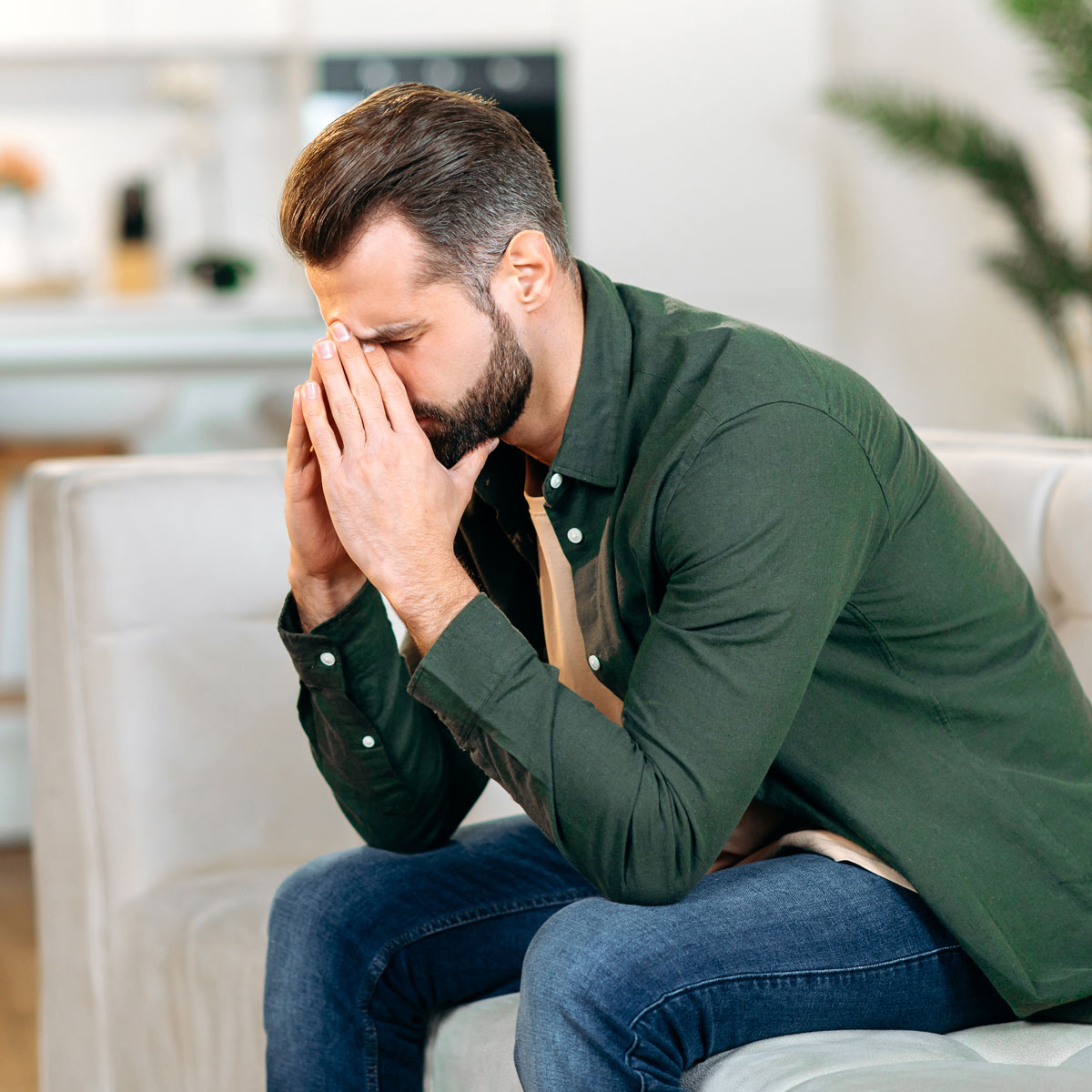 unhappy-frustrated-caucasian-man-sit-on-sofa-in-l-2022-10-21-01-47-48-utc.jpg