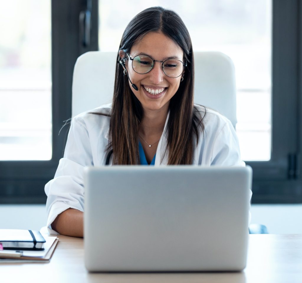 female-doctor-talking-with-colleagues-through-a-video-call-with-a-laptop-in-the-consultation-1-2.jpg