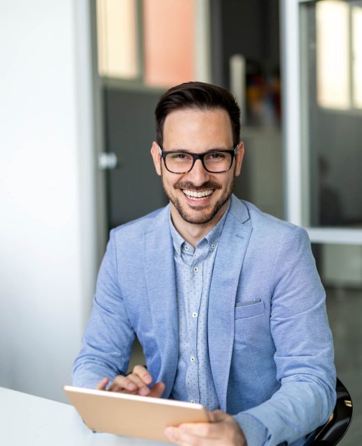 smiling-business-man-using-digital-tablet-in-the-o-2021-08-30-00-05-58-utc.jpg