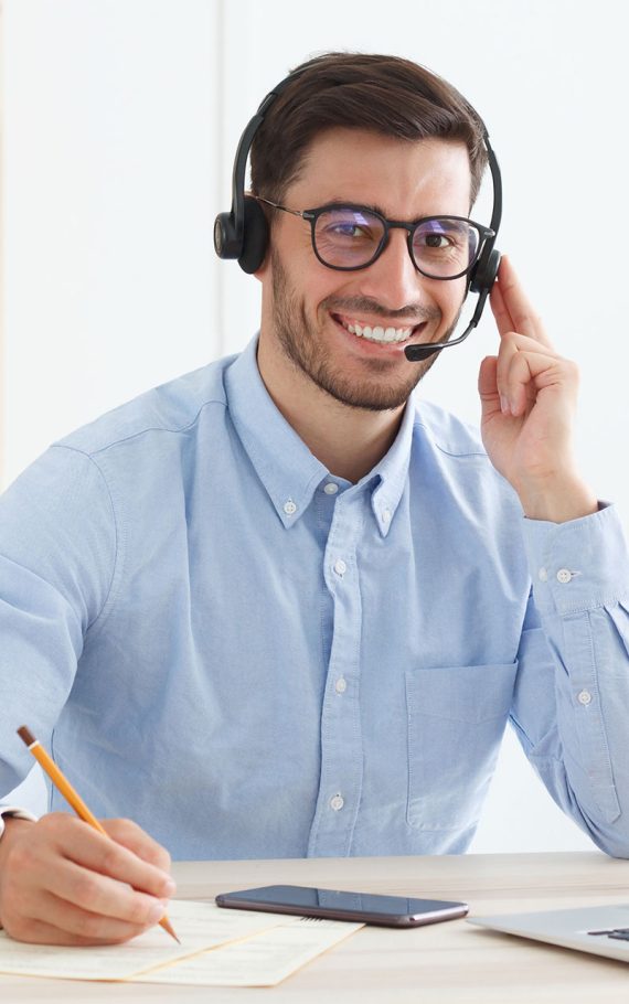 smiling-male-customer-service-worker-sitting-with-2023-11-27-05-29-53-M7BJ96J.jpg