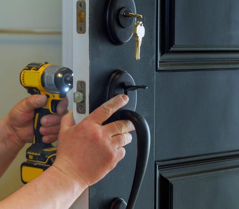 closeup-of-a-professional-locksmith-installing-a-new-lock-on-a-house-exterior-door-with-the-inside-e1696769086563.jpg