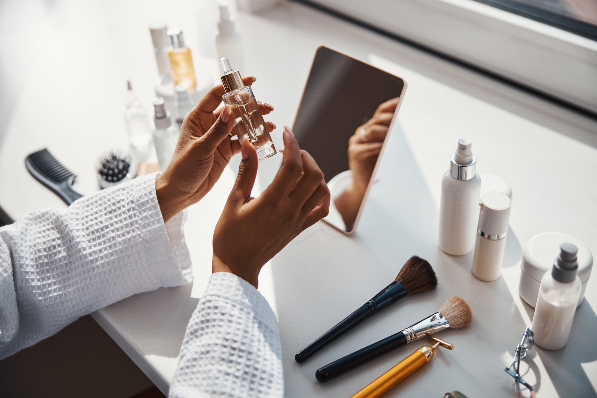 female-hands-holding-bottle-of-vitamin-face-serum.jpg