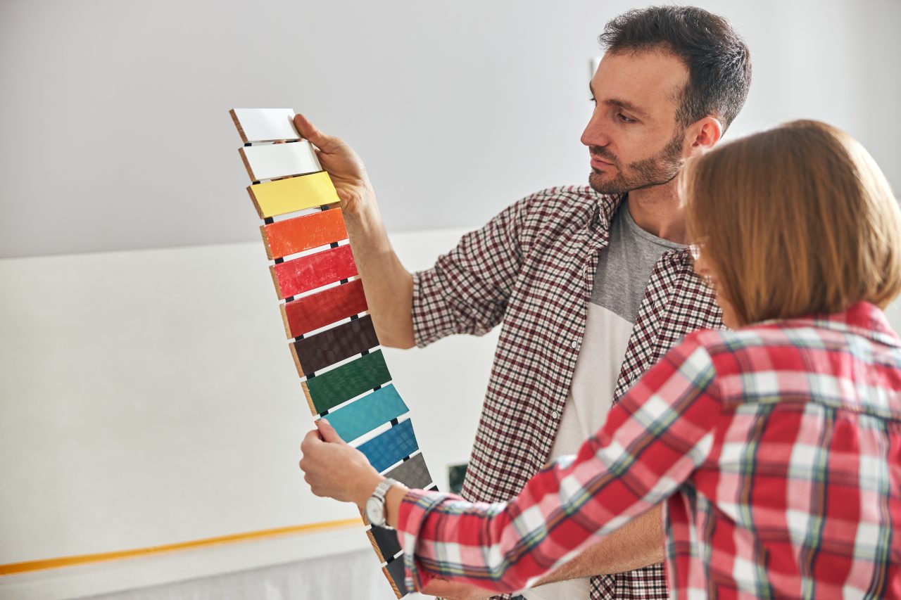 worker-and-an-apartment-owner-choosing-the-color-palette-e1698216470315