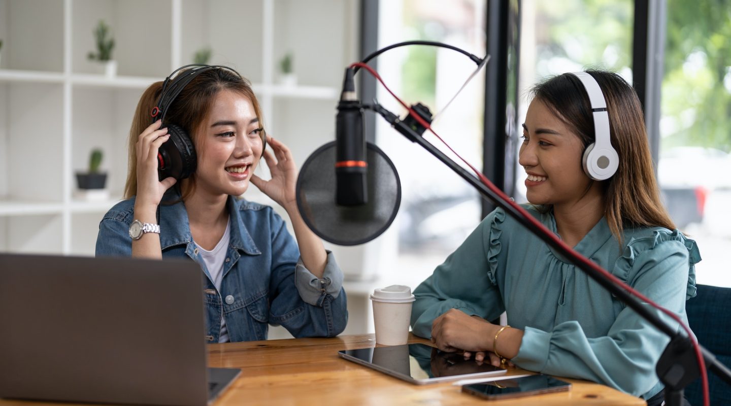 two-asian-radio-podcasters-recording-interview-each-other-for-radio-podcast-.jpg