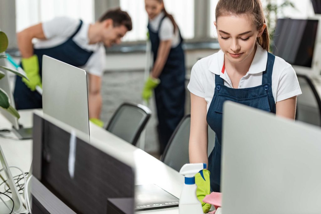 selective-focus-of-pretty-cleaner-wiping-desk-whil-LCRNJVY.jpg