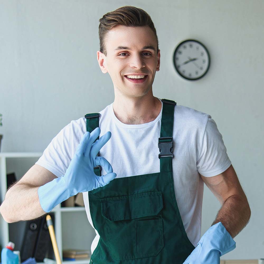 handsome-smiling-young-cleaner-holding-bucket-with3-SURKJ7F.jpg