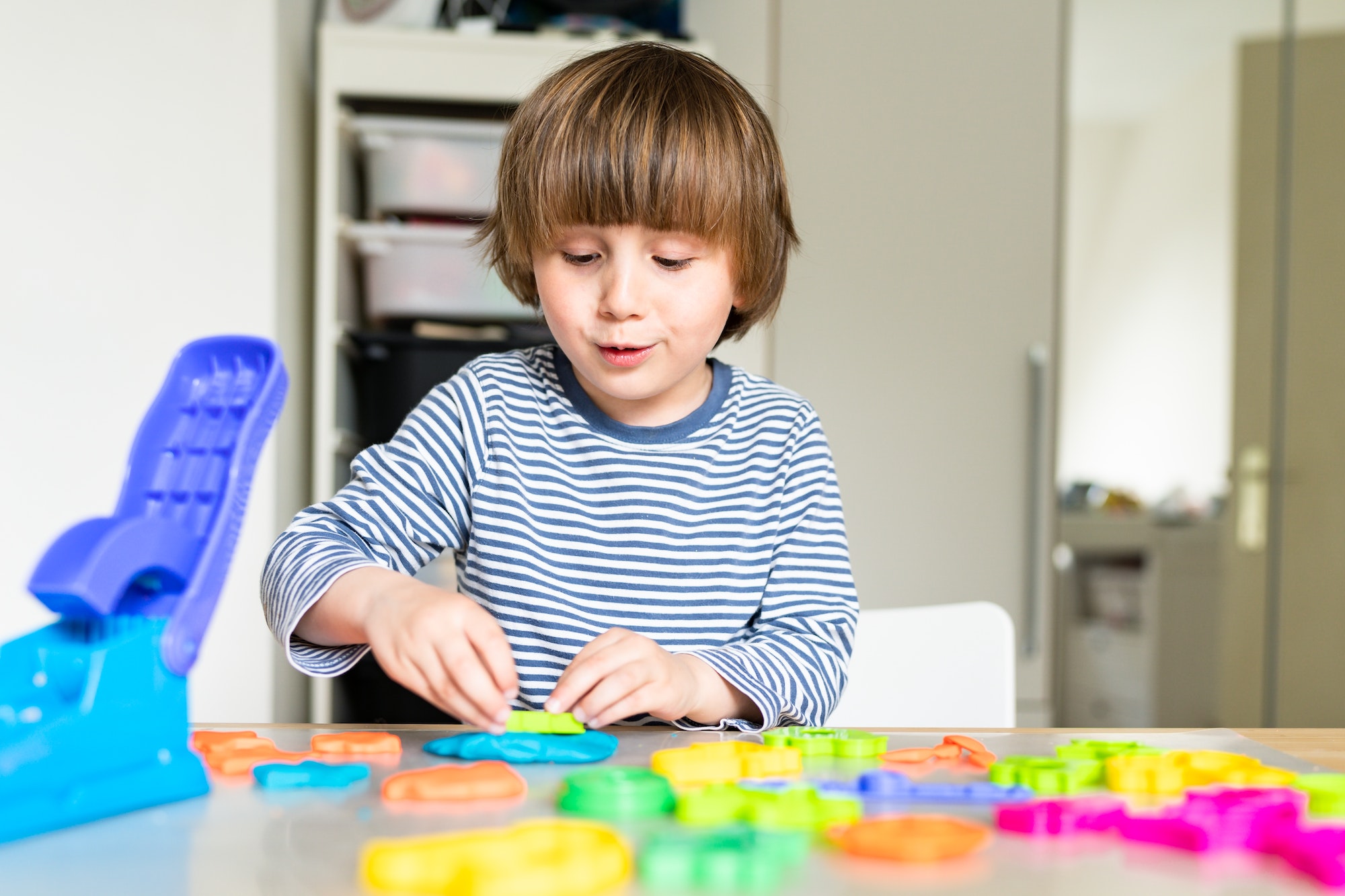 toddler-child-playing-with-modeling-compound-set-at-home-kid-early-development-creative-play-.jpg