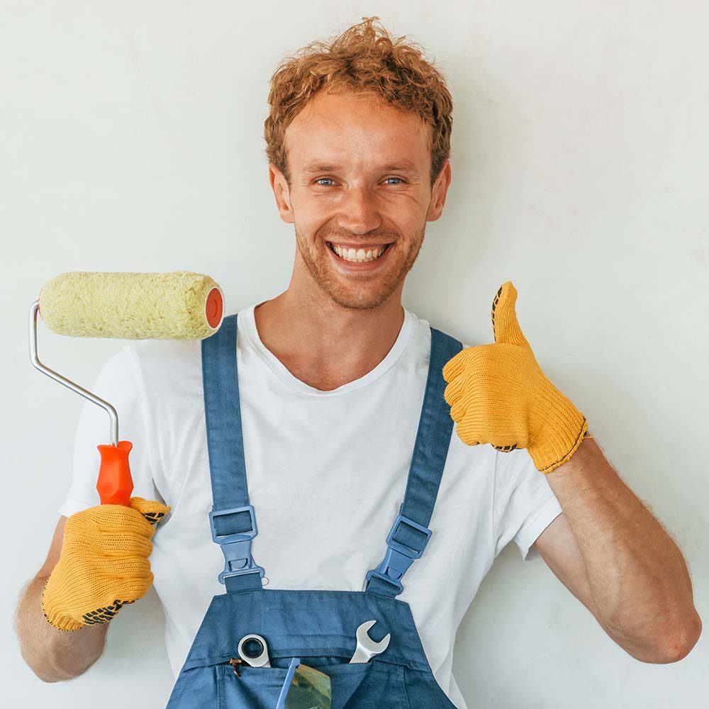 painting-the-walls-young-man-working-in-uniform-a-3NZVSVD.jpg