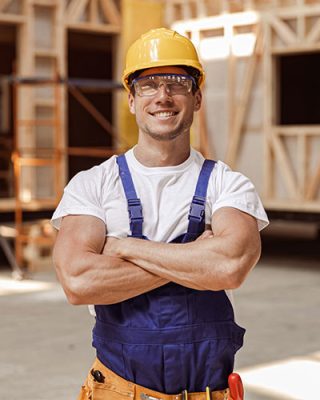 cheerful-young-man-builder-standing-at-constructio-2021-10-06-18-11-26-5UEXT86