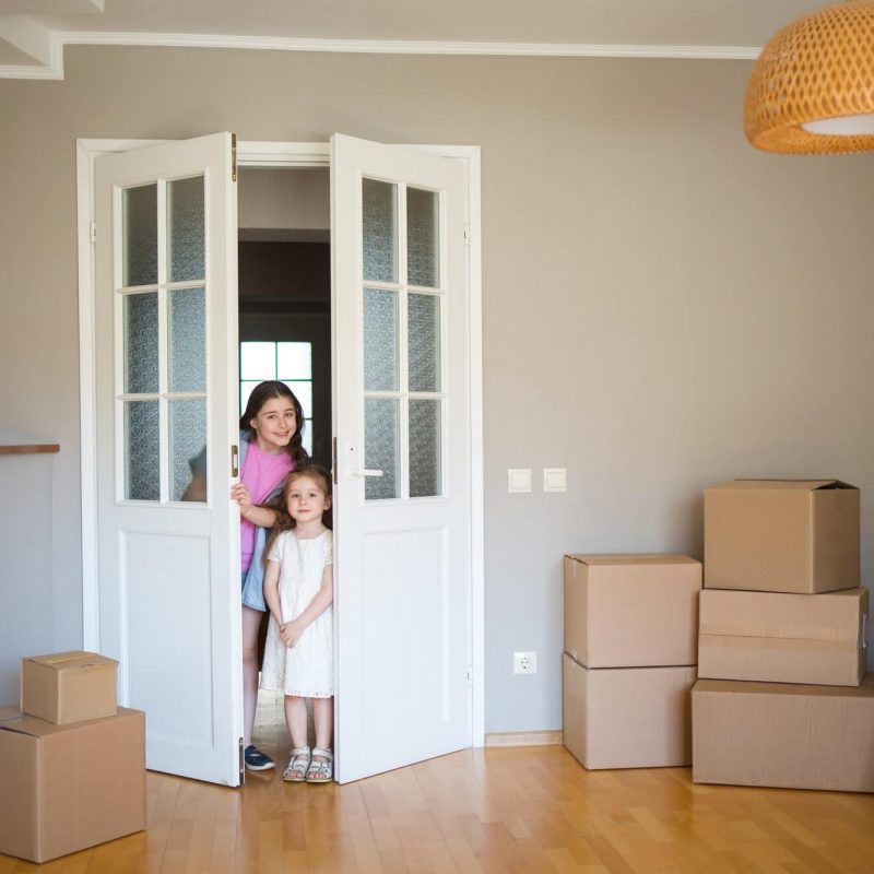 children-look-into-its-new-home-moving-to-apartment-boxes-in-house-1-1-pe7ens5cezdx52k08qcjr6hq6tph192al0argl24ao