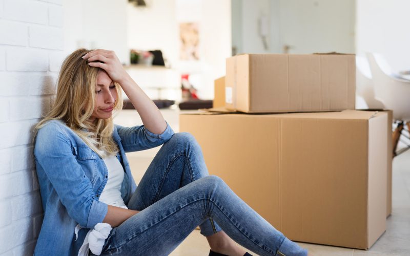 tired-woman-exhausted-while-moving-into-new-home-SB84W23.jpg