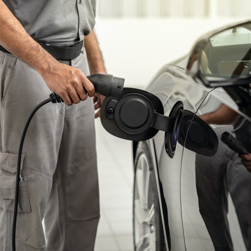 closeup-asian-technician-hand-is-charging-the-electric-car-or-ev-in-service-center.jpg