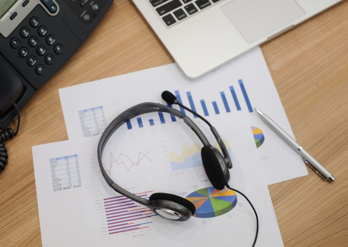 close-up-blurred-of-headset-of-call-centre-at-computer-office-room-with-financial-report-concept-.jpg