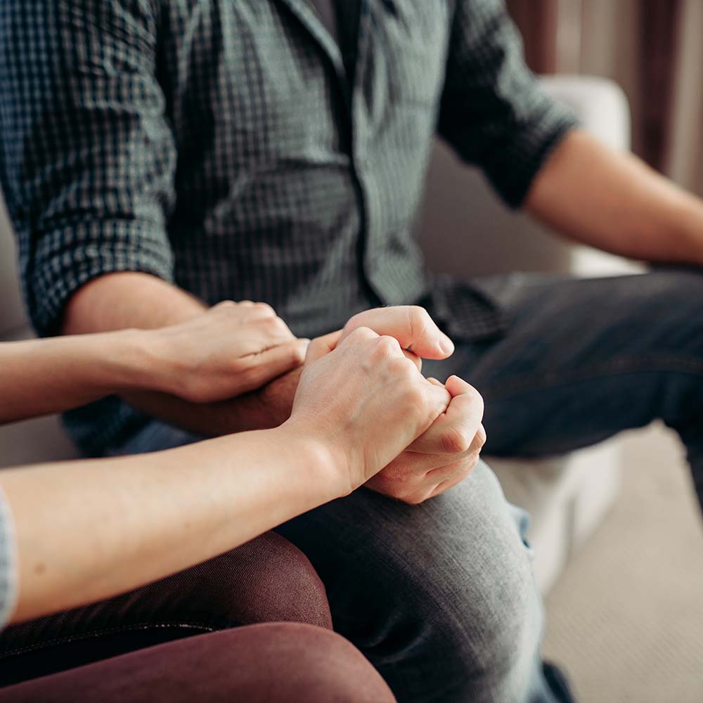 Couple hold hands at psychologist, family psychology support, civilized solution to the problem. Female doctor helps patients with consultation