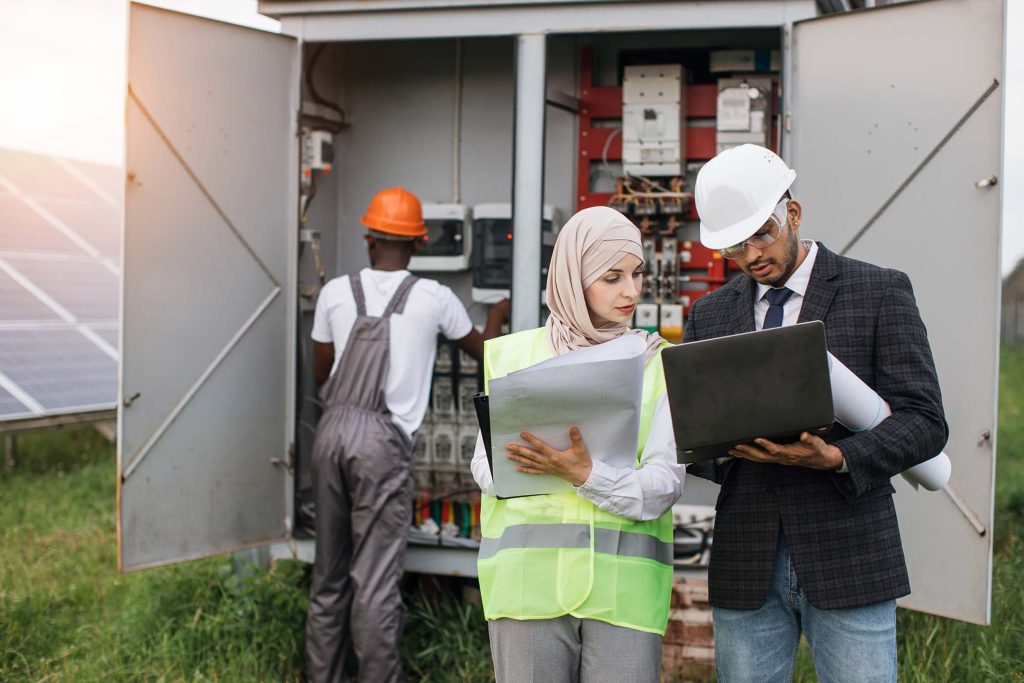 multi-ethnic-people-having-meeting-at-solar-statio-EMGZT89.jpg