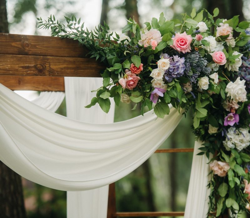 wedding-ceremony-on-the-street-on-the-green-lawn-decor-with-fresh-flowers-arches-for-the-ceremony.jpg