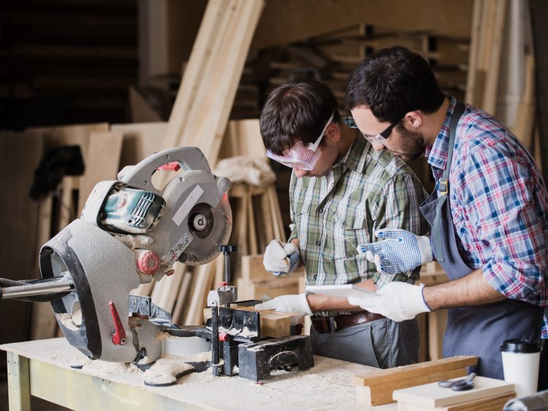 inspector-and-carpenter-discuss-the-process-of-making-wood-products-for-furniture.jpg